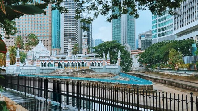 Malaysia - June 10, 2025: Panoramic view of the Masjid Jamek Sultan Abdul Samad Mosque and the confluence of the Klang and Gombak rivers with skyscrapers in the capital city of Kuala Lumpur.4К