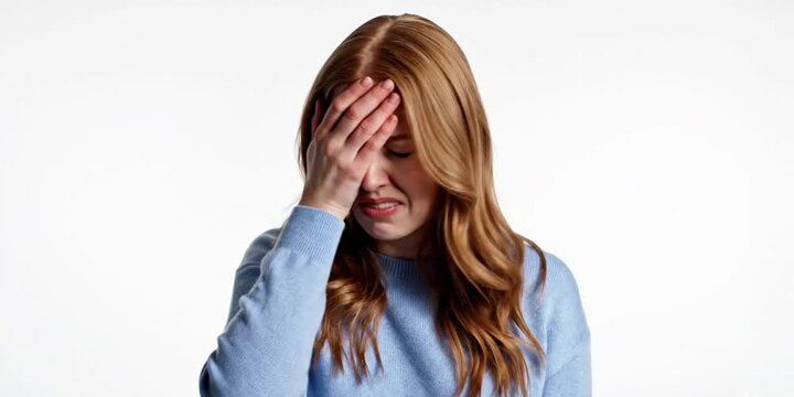 Confused young woman shrugging shoulders and making facepalm gesture. Disappointed female feeling embarrassment or making mistake isolated on white background