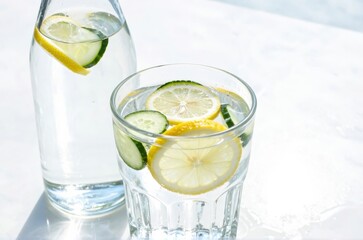 Refreshing Detox Water with Lemon and Cucumber Slices in Sunlight