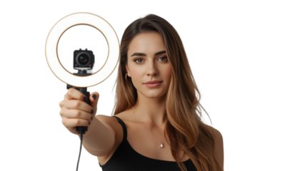 A young woman holding a ring light with a camera on it on transparent background