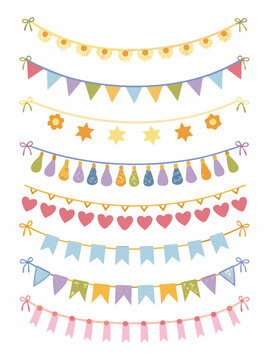 Colorful party decorations with various flag and star garland designs isolated on white