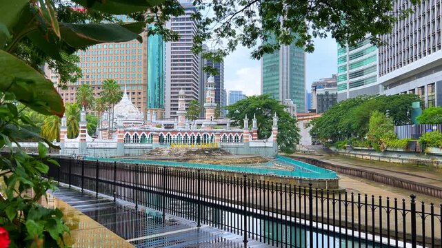 Malaysia - June 10, 2025: Panoramic view of the Masjid Jamek Sultan Abdul Samad Mosque and the confluence of the Klang and Gombak rivers with skyscrapers in the capital city of Kuala Lumpur.4К