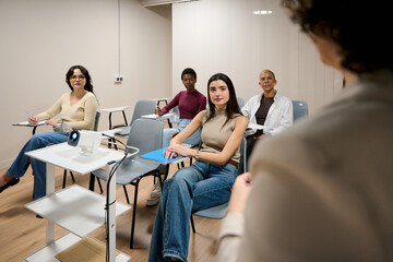 Diverse women students attending university lecture in classroom