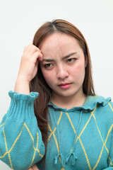 Portrait of a young stressed Asian woman against white background thinking
