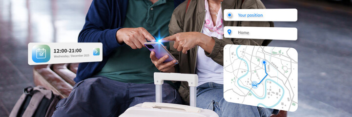 Asian adult couple travelers using smartphone for digital journey planning at public transport station interactive mobile navigation app trip scheduling