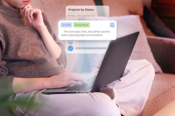 Asian young adult person focused on deep work using laptop computer at home comfortable sofa concentrating on important digital tasks