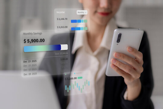 Asian adult woman managing personal finance through smartphone digital interface viewing holographic savings data investment growth budget planning for future financial success - Powered by Adobe