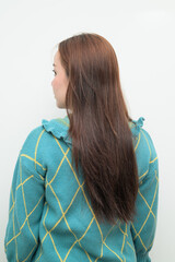 Portrait of a young Asian woman against white background