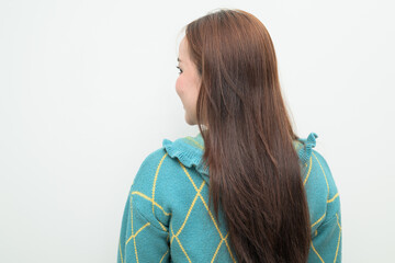 Portrait of a young Asian woman against white background