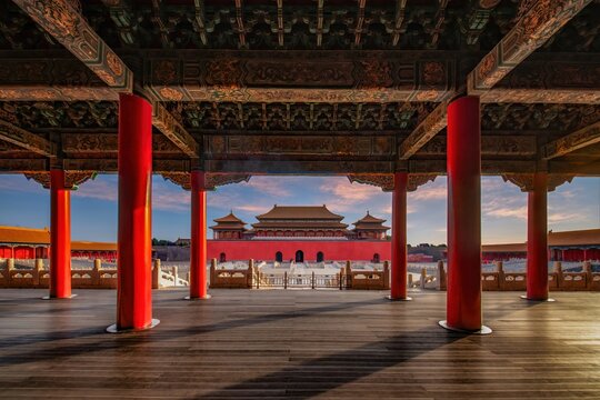 A panoramic view of the Wumen Gate at the Forbidden City, showcasing the grand architecture and vibrant colors under the golden sunlight.