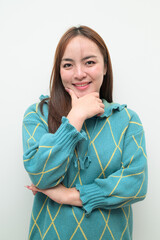 Portrait of a young happy Asian woman against white background thinking