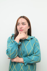Portrait of a young Asian woman against white background thinking