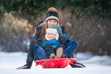 Mom Takes Son on Sled Ride