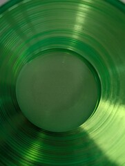 Abstract green glass composition with circular lines and reflections, artistic minimal background concept.