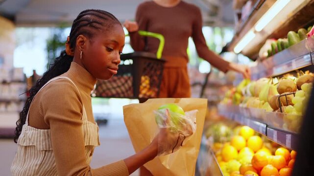 African american woman buying fresh fruit at grocery store