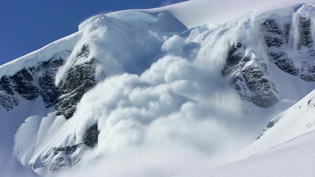 Massive snow avalanche rushing down mountain in alpine landscape captured in dramatic sequence