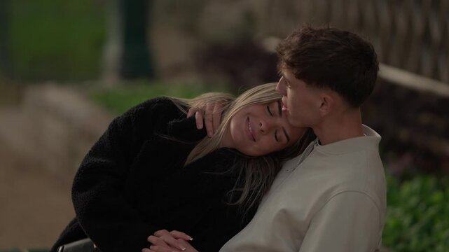 A young couple is seen embracing affectionately in Paris France The man and woman are in love hugging in an outdoor setting The clip features slow motion or handheld camera work capturing an intimate 
