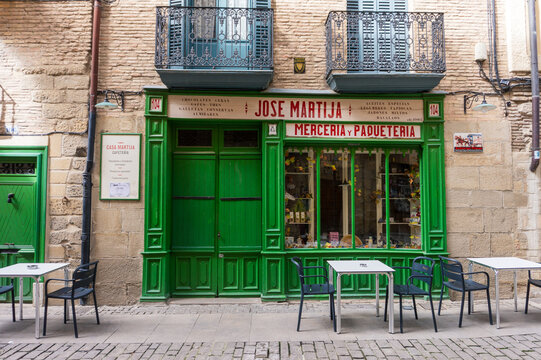 Puente de la Reina, Navarra, Spain,  25 MARCH 2025: view of an ancient shop with the green sign 