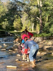 Group of friends wearing vibrant ethnic fashion having fun by the water.