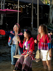 Group of friends wearing vibrant ethnic fashion having fun by the water.