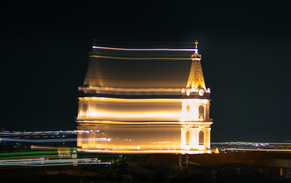 Abstract motion blur of illuminated church tower and city lights at night in Jerusalem.