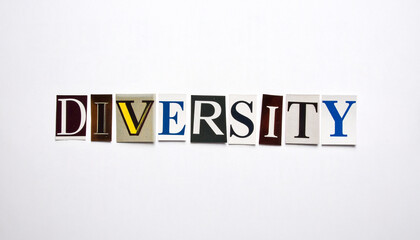 The word DIVERSITY composed of multicolored cutout letters from magazines on a white background. Concept of inclusion, equality, multiculturalism, community, and social integration in society.