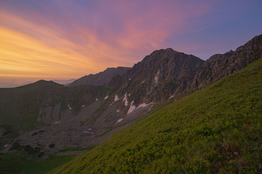 Aerial view of rugged mountain peaks touched by the soft glow of the pastel sky, Krupova Hola, Zilina Region, Slovakia.