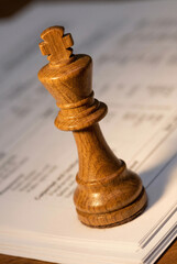 Oak chess piece on white documents symbolizing strategic business planning