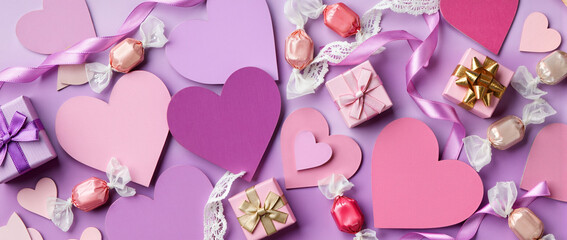 Dense scatter of paper hearts, ribbons, lace, gift boxes, and candies over a soft lavender gradient. Realistic textures, soft lighting, ideal for Valentine&rsquo;s Day visuals.