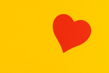 beautiful red hearts made of plastic and film pasted on yellow paper, red symmetrical heart-shaped stickers on bright paper