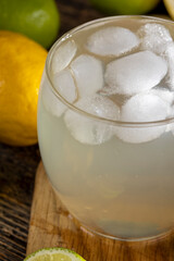 cold lemon drink with the addition of pieces of pure ice , sweet and sour refreshing drink with lemon flavor and whole juicy lemons and limes