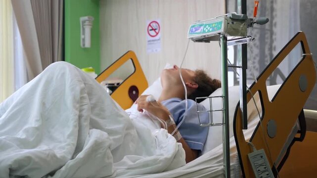 Young female patient experiencing pain and discomfort while lying sick in a hospital bed with an iv drip, restless and unable to sleep during her medical treatment and recovery period