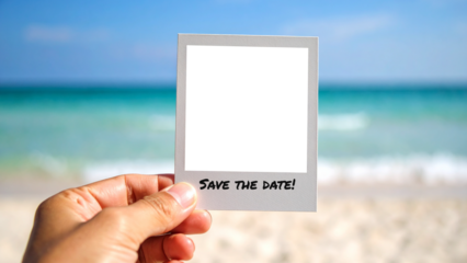 Hand holds an instant photo frame with 'Save the date' text over a tropical beach. Concept for wedding or event announcement with a transparent background for easy overlay and composition.