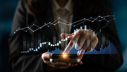 A business professional uses a smartphone to analyze financial data, featuring digital graphs that display market trends and economic insights for informed decision-making. Scalp