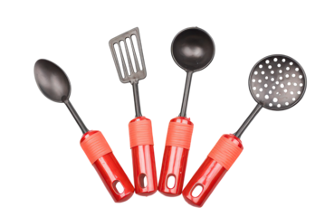 Collection of Kitchen Utensils Including Spoon, Turner, Ladle and Skimmer Hanging with Red Handles on Transparent Backdrop in Studio Photography