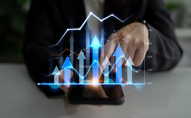 A businessman interacts with a smartphone displaying vibrant digital graphs and trends, symbolizing growth, analytics, and modern business strategies. Scalp