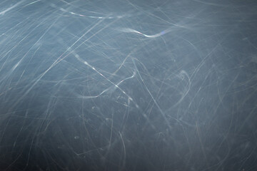 Dust particles or white snow scatter haphazardly through the air and shimmer in the spotlight,...