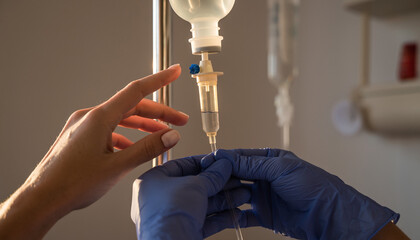 Medical professional adjusting intravenous drip in a clinical setting