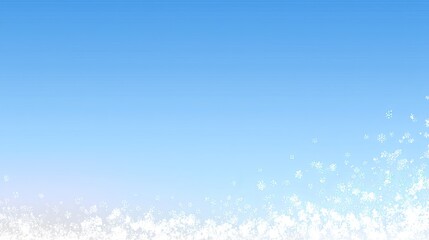 Snowflakes fall gently from the sky, creating a white layer on the ground under a bright blue atmosphere