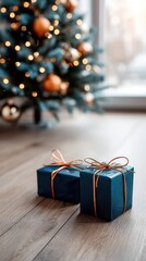 Presents of different colors are placed on a wooden floor in front of a decorated tree while soft lights decorate the background