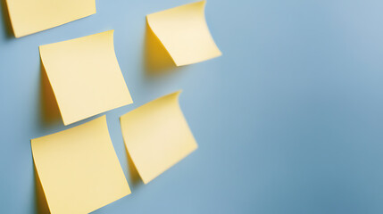 Idea organization with sticky notes. These bright yellow notes provide visual cues for reminders, brainstorming, and planning, against a pale blue background.