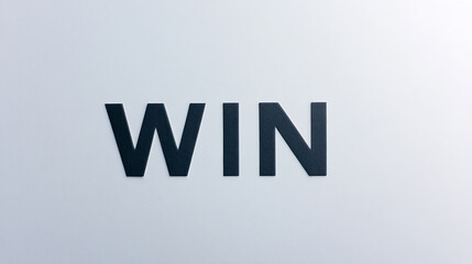 The image shows the word "WIN" in big, bold letters that stand out against a plain background. It's a clear, simple message about success and achievement. A reminder to aim high!