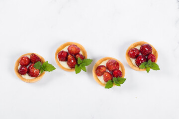 Mini dessert. Mini Wild Strawberry tartlets. Light background. Top view	