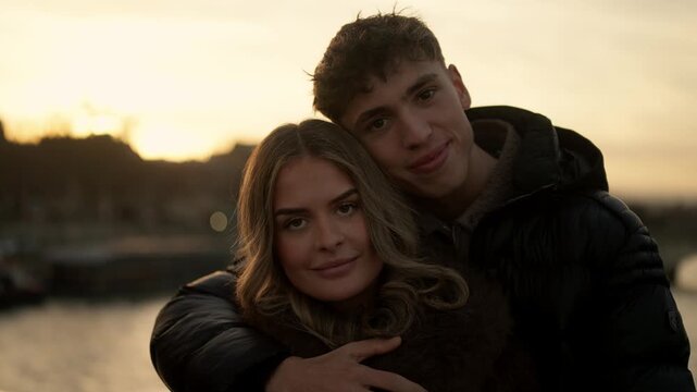 A young couple embraces in Paris France at sunset The slow motion portrait captures a romantic and affectionate moment between the lovers during golden hour The scene evokes feelings of love travel an