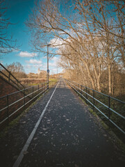 Fototapeta premium Empty pedestrian and cycle path with strong perspective on a sunny day