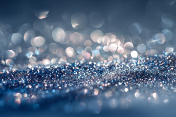 Sparkling blue and silver glitter particles creating a magical bokeh effect with soft focus reflections and shimmering light highlights in a dreamy abstract scene