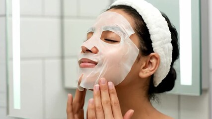 Capturing a serene moment Young woman's daily beauty ritual with a revitalizing sheet mask for healthy skin