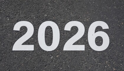 Monochromatic, high-contrast close-up of the bold white 2026 digits representing the future on dark asphalt.
