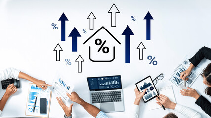 A collaborative business environment showcasing a team analyzing financial data with laptops and tablets, surrounded by growth symbols and percentage graphics for insightful decision-making. Gantry