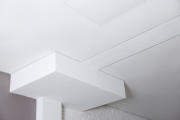 Tiled ceiling with lighting and cctv camera indoors, low angle view